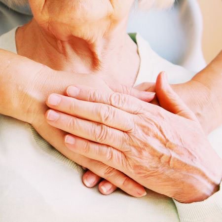 Young female hands hugging old woman, closeup. Giving support during body donation