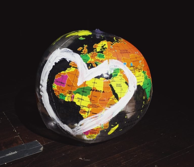 Globe with a heart painted on it, representing the compassion that goes into MedCure's pacemaker recycling program