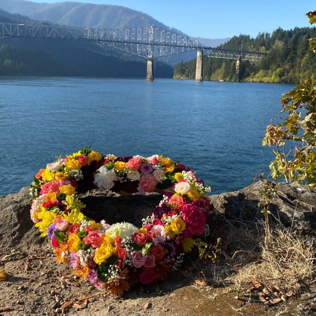 Floral wreath in the shape of a heart with Columbia River in background