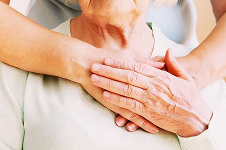 Young female hands hugging old woman, closeup. Giving support during body donation