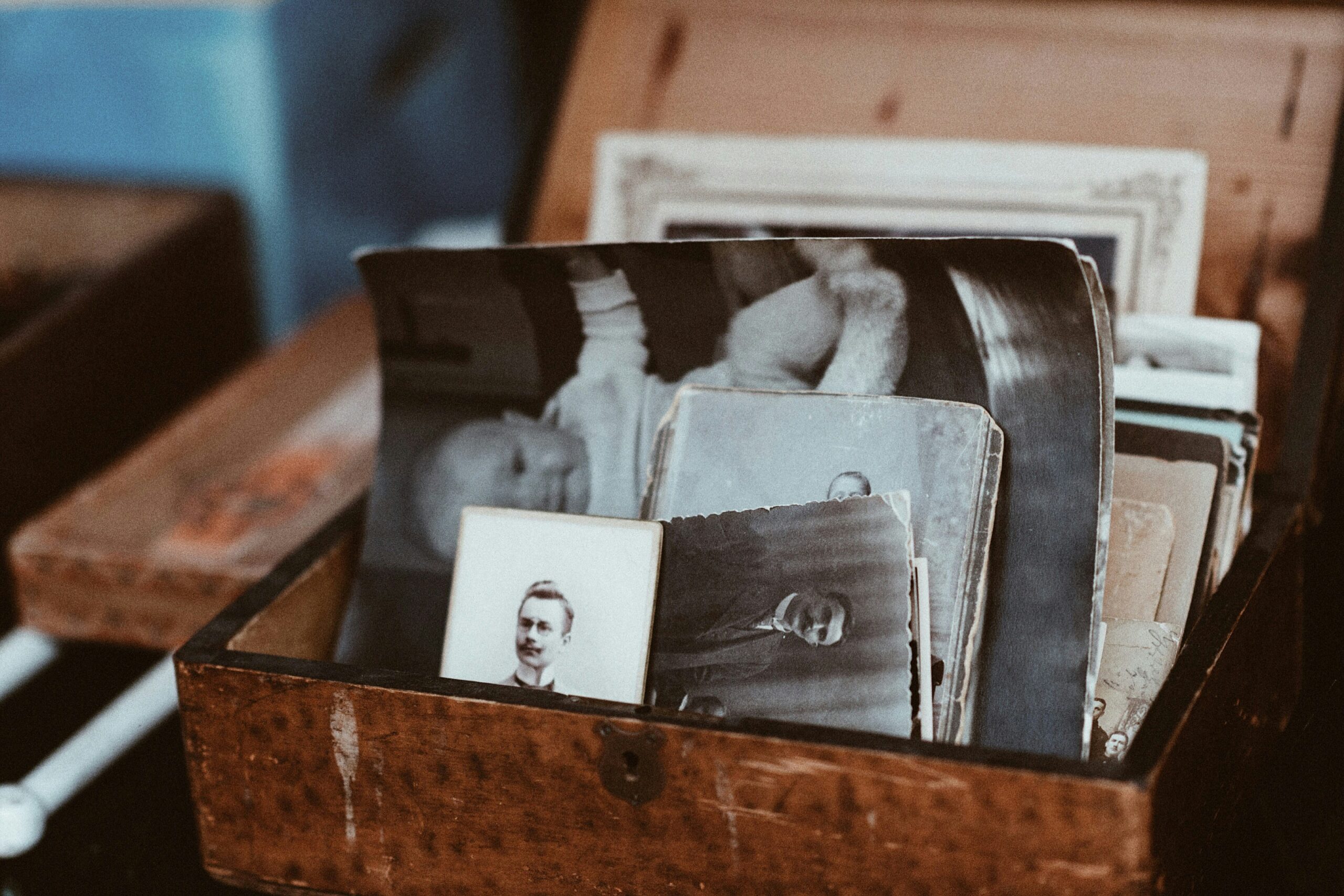 A wooden box filled with vintage black-and-white photographs, representing memories, history, and the lasting legacy of individuals—symbolic of the contributions made through whole body donation to medical science and education.